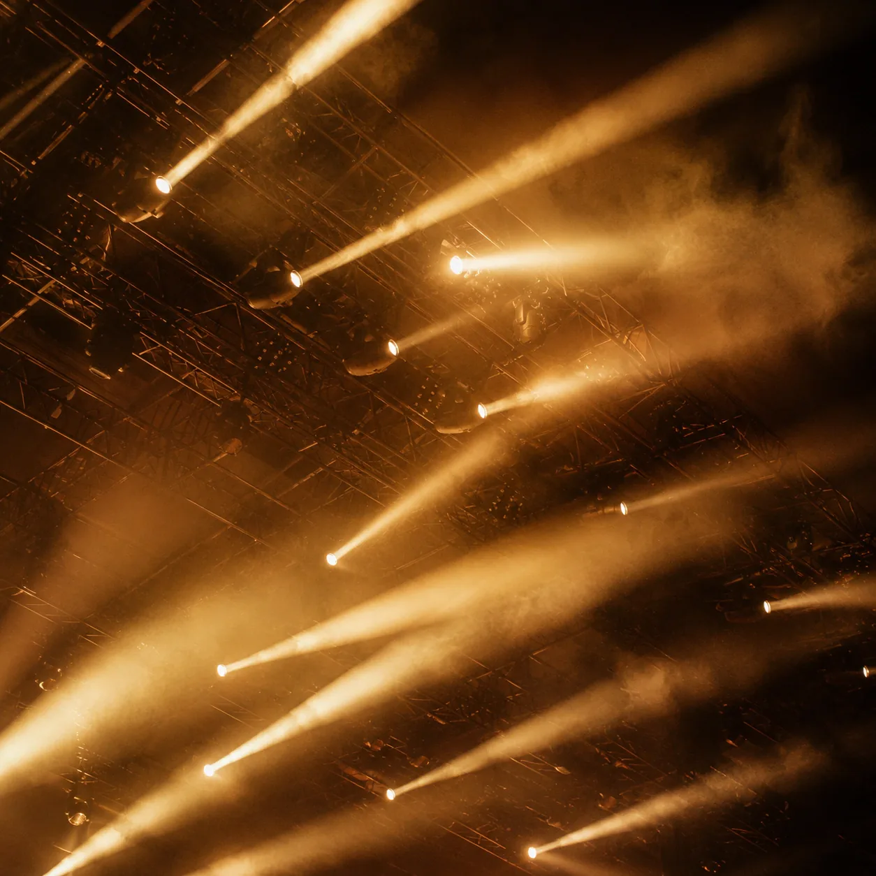 Amber stage lighting rig in haze